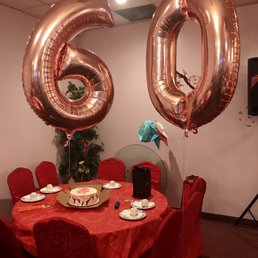 a table with a red tablecloth and red chairs a table with a red tablecloth and red chairs