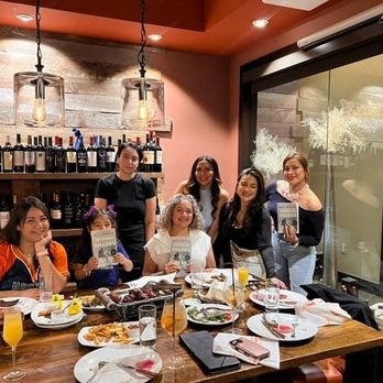 Sal Y Pimienta Kitchen - Book club in the wine room - Latin American Near Me - Houston, Texas