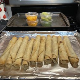 Five Rolled Tacos with Cheese and Guacamole