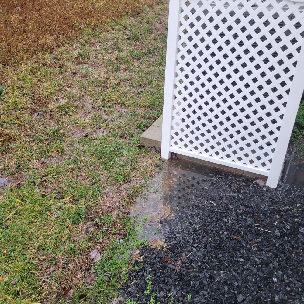 New bloom Landscaping - Before: Standing water on the side of the house. - Landscaping Near Me