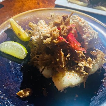 Cafe La Trova - up close of the Lechon con chicharrones on yuca - Cocktail Bars Near Me - Miami, Florida