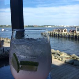 a glass of water with a lime slice in it a glass of water with a lime slice in it