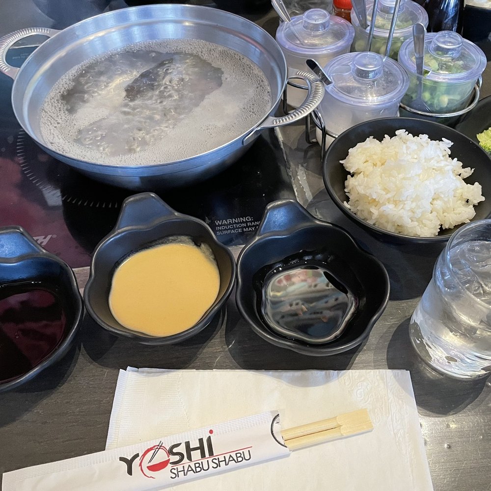 The set up: hot pot, sauces, veggies, rice bowl, garnishes