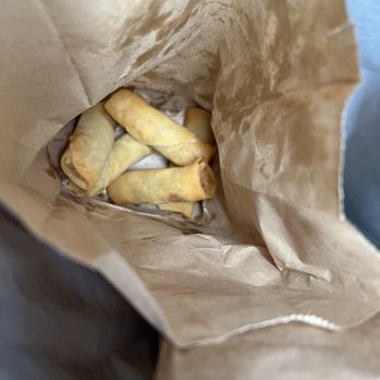 Samosa King - Embassy Restaurant - a person opening a brown paper bag - Indian Near Me - Scarborough, Ontario Samosa King - Embassy Restaurant - a person opening a brown paper bag - Indian Near Me - Scarborough, Ontario