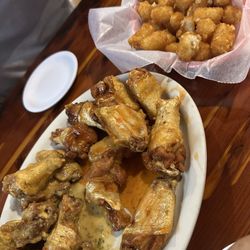 Brahma Bull Restaurant - Garlic parm and sweet chili wings.  Tater tots
