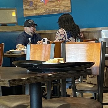 Denny's - 2 dirty food trays sitting on a guest table, that the "server" touched 3 times and never took it to the back. - Breakfast & Brunch Near Me - Temple, Texas