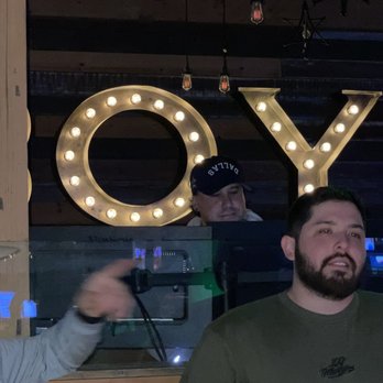 PBR Texas - two men standing in front of a sign that says joy - Sports Bars Near Me - Arlington, Texas PBR Texas - two men standing in front of a sign that says joy - Sports Bars Near Me - Arlington, Texas