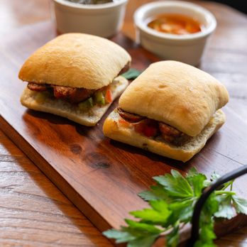Bodegón by Domingo Sausage - two sandwiches on a cutting board - Comfort Food Near Me - Carbondale, Colorado Bodegón by Domingo Sausage - two sandwiches on a cutting board - Comfort Food Near Me - Carbondale, Colorado