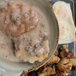 Biscuits and turkey sausage gravy with seasoned potatoes and eggs
