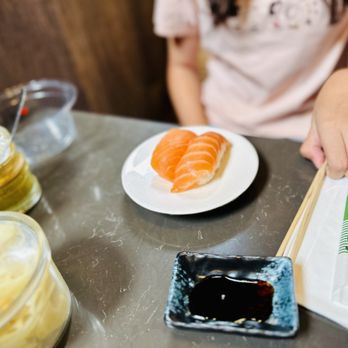 Sushi Hada - a person sitting at a table with a plate of sushi - Sushi Bars Near Me - Portland, Oregon Sushi Hada - a person sitting at a table with a plate of sushi - Sushi Bars Near Me - Portland, Oregon