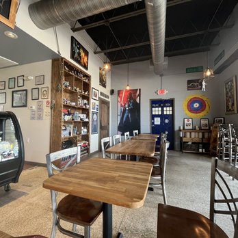 Ploughman's Deli & Cafe - Seating area with ample sci-fi memorabilia on the bookshelf - Cafes Near Me - Houston, Texas