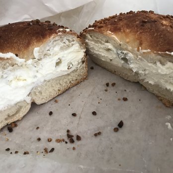Bagels Plus - Garlic bagel with greek olive cream cheese. Soooo much cream cheese - Bagels Near Me - Tampa, Florida
