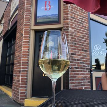 Bontzu Cellars - a glass of white wine on a table - Wine Tasting Room Near Me - Walla Walla, Washington Bontzu Cellars - a glass of white wine on a table - Wine Tasting Room Near Me - Walla Walla, Washington