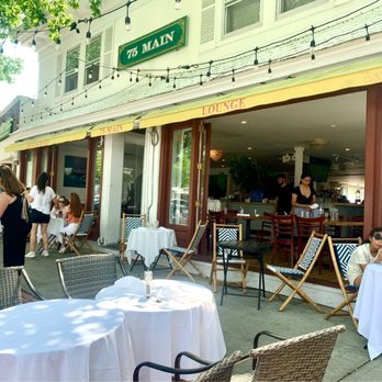 75 Main - Very popular outside seating area. Nicely shaded at lunchtime. Doors are wide open for some inside seating to feel part of the outside - New American Near Me - Southampton, New York 75 Main - Very popular outside seating area. Nicely shaded at lunchtime. Doors are wide open for some inside seating to feel part of the outside - New American Near Me - Southampton, New York