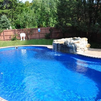 Albert Group Pools & Patios - A stunning Leisure Pools Riviera 34 in Sapphire Blue with bullnose paver coping, paver patio and natural rock waterfall. - Pool & Hot Tub Service Near Me - Salisbury Mills, New York Albert Group Pools & Patios - A stunning Leisure Pools Riviera 34 in Sapphire Blue with bullnose paver coping, paver patio and natural rock waterfall. - Pool & Hot Tub Service Near Me - Salisbury Mills, New York