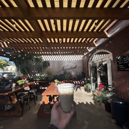 Exterior outside entrance of Nambah Coffee - Outside seating and brown coconut coffee - La Verne, California Exterior outside entrance of Nambah Coffee - Outside seating and brown coconut coffee - La Verne, California