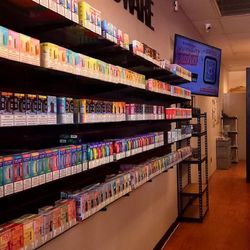 Red Star Vapor & Smoke - Product - Disposable vape and ejuice wall featuring brands like Lost Mary, Geek Bar, Juice Head, Off-Stamp, and more.