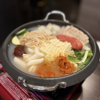 Soondol Tofu House - Spicy kimchi stew-- additional items: dumplings, sausage, boiled pork belly, and rice cake. Ramen and potato noods added later - Korean Near Me - Los Angeles, California Soondol Tofu House - Spicy kimchi stew-- additional items: dumplings, sausage, boiled pork belly, and rice cake. Ramen and potato noods added later - Korean Near Me - Los Angeles, California