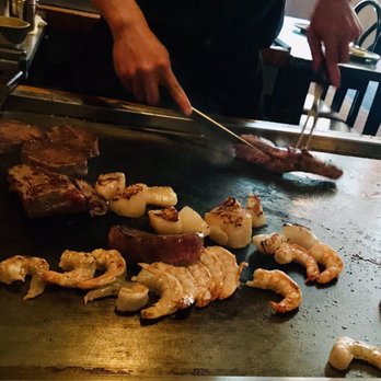 Simon's - a chef preparing food on a grill - Tapas Bars Near Me - Horseheads, New York