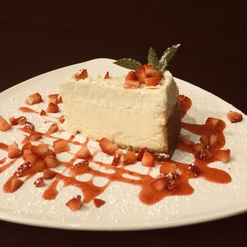 The District Tap - New York style cheesecake with strawberry purée - Sports Bars Near Me - Indianapolis, Indiana The District Tap - New York style cheesecake with strawberry purée - Sports Bars Near Me - Indianapolis, Indiana