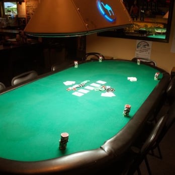 Match Ups Pool Hall - a poker table with cards and chips - Pool Halls Near Me - Fort Collins, Colorado
