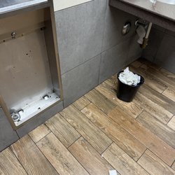 Men's room.. clothes in trash!?