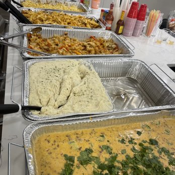 Kam's Kitchen - a variety of food in pans - Food Delivery Services Near Me