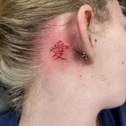 Pensacola Tattoo Studio - Garra's "self love" from Naruto behind the right ear