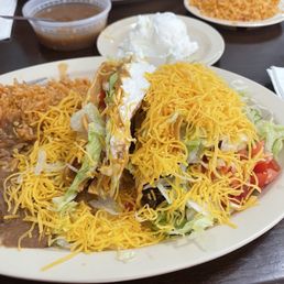 Two crunchy tacos, rice and beans Two crunchy tacos, rice and beans