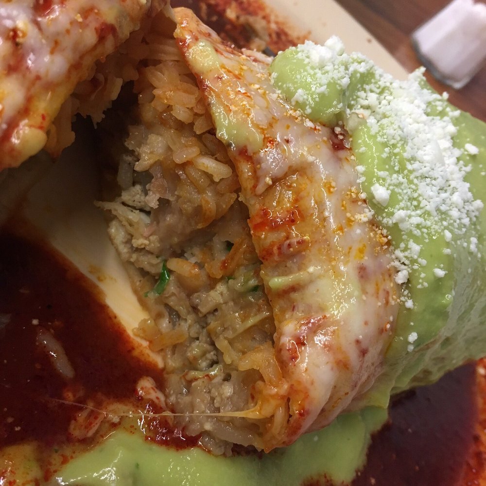 El Gallito - Inside the burrito mojado (wet burrito). Super good and tasty, filling too. Topped with mozzarella, queso fresco, guacamole and crema. - Mexican Near Me - Los Angeles, California