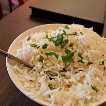 Royal India - a bowl of white rice with a spoon - Indian Near Me - San Diego, California Royal India - a bowl of white rice with a spoon - Indian Near Me - San Diego, California