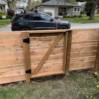 Wapato Construction - a wooden fence with a black car in the background - General Contractors Near Me