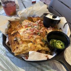 Latitude Bar and Grill - Nachos with a side of jalapeños .
