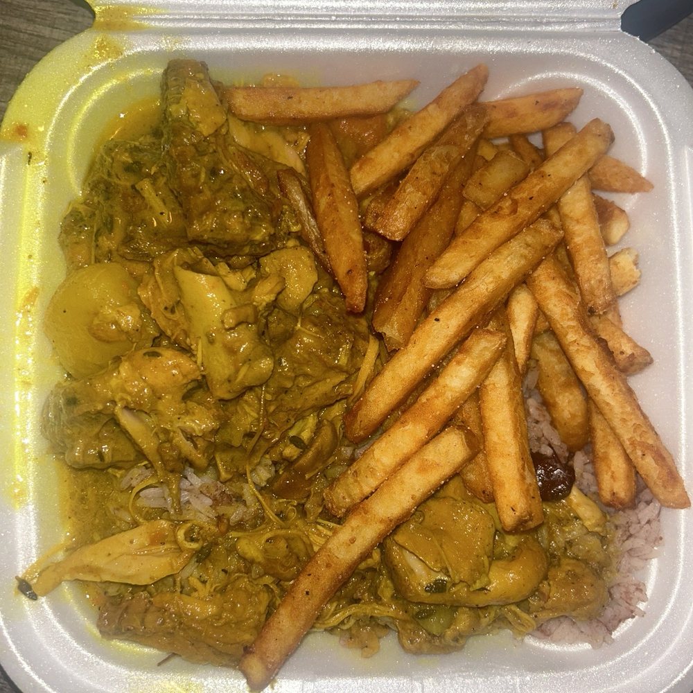 Curry chicken with rice & peas and fries Curry chicken with rice & peas and fries