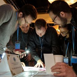 BreakoutIQ - Participants pour over clues during our thrilling escape room game