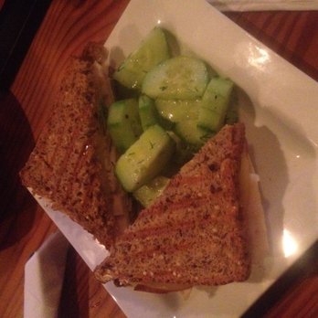 Mullers Cider House - Hot-pressed turkey and gouda on gluten free bread, with a side of cucumber salad. - Bars Near Me - Rochester, New York Mullers Cider House - Hot-pressed turkey and gouda on gluten free bread, with a side of cucumber salad. - Bars Near Me - Rochester, New York
