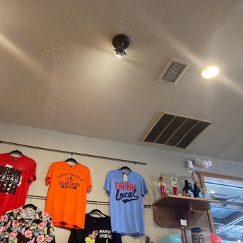 Cedar Creek Brewery - t - shirts hanging on the wall - Breweries Near Me - Seven Points, Texas Cedar Creek Brewery - t - shirts hanging on the wall - Breweries Near Me - Seven Points, Texas