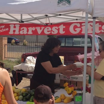 Harvest Gifts - a woman handing a box of fruit to a child - Arts & Crafts Near Me - Albuquerque, New Mexico