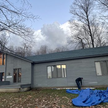 JT's Contracting - a house with a blue tarp on the ground - Roofing Near Me JT's Contracting - a house with a blue tarp on the ground - Roofing Near Me