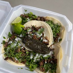 two tacos in a styrofoam container two tacos in a styrofoam container