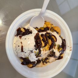 Milk& cookies and cappaccino crunch topped with hot fudge and nuts Milk& cookies and cappaccino crunch topped with hot fudge and nuts