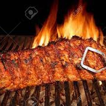 Tri-M's Market - a piece of meat on a grill with flames in the background - Grocery Near Me - Traver, California Tri-M's Market - a piece of meat on a grill with flames in the background - Grocery Near Me - Traver, California