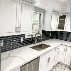 Premier Construction & Development - Kitchen remodels. Backsplash, flooring, quartz counter tops, new cabinets, fresh paint, and recessed lighting.