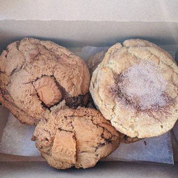 The Cookie Box - Snickerdoodle, salted chocolate chip, and Biscoff cookie butter cookies! - A box contains three cookies: a snickerdoodle, a salted chocolate chip, and a Biscoff cookie butter cookie, with visible textures and sugar dusting. - Desserts Near Me - Cottleville, Missouri