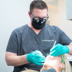 Gardenia Dentistry - Dr. Rediger examining patients overall oral health.