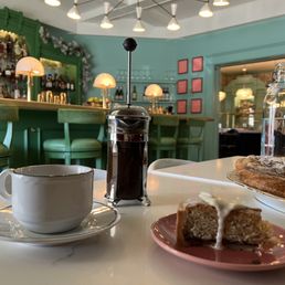 Raspberry almond cake + fresh French press coffee. Beautiful ambiance & more delicious pastries awaiting. Raspberry almond cake + fresh French press coffee. Beautiful ambiance & more delicious pastries awaiting.