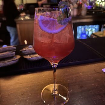 Hanzo - a drink in a wine glass on a bar - Sushi Bars Near Me - San Antonio, Texas Hanzo - a drink in a wine glass on a bar - Sushi Bars Near Me - San Antonio, Texas