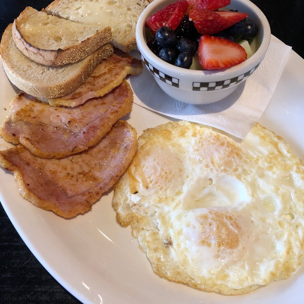 Rise & Dine Eatery - $12.50 - Fried eggs with peameal bacon and fruit salad. - Breakfast & Brunch Near Me - Toronto, Ontario Rise & Dine Eatery - $12.50 - Fried eggs with peameal bacon and fruit salad. - Breakfast & Brunch Near Me - Toronto, Ontario