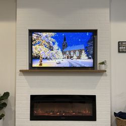 Electric fireplace with a TV frame