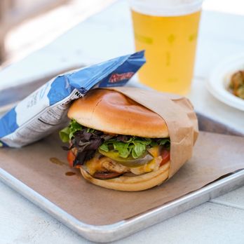 The Bend - Our Yardbird sandwich- Grilled chicken with cheddar jack cheese, green tomato relish, jalapeno, white bbq sauce, lettuce, tomato, onion. - Beer Bar Near Me - Bentonville, Arkansas